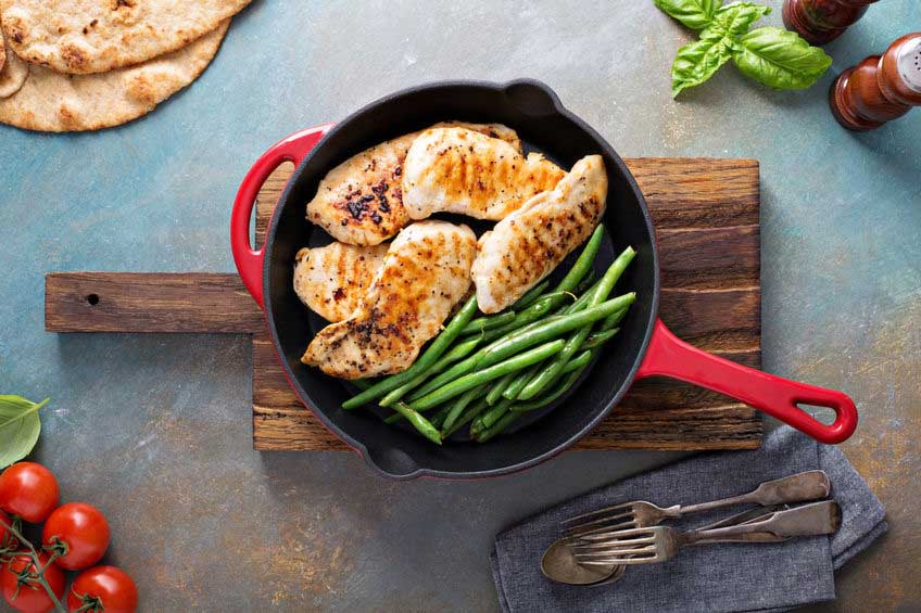Potatoes, Green Beans and Chicken in a cast iron skillet